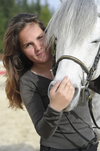   Woman playing with her horse — Stockfoto